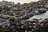 Aerial view of Bergen with colorful waterfront buildings, Bryggen and boats in the harbor at dusk.